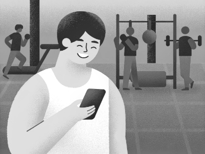 A person in the gym smiling at a reminder on their phone.